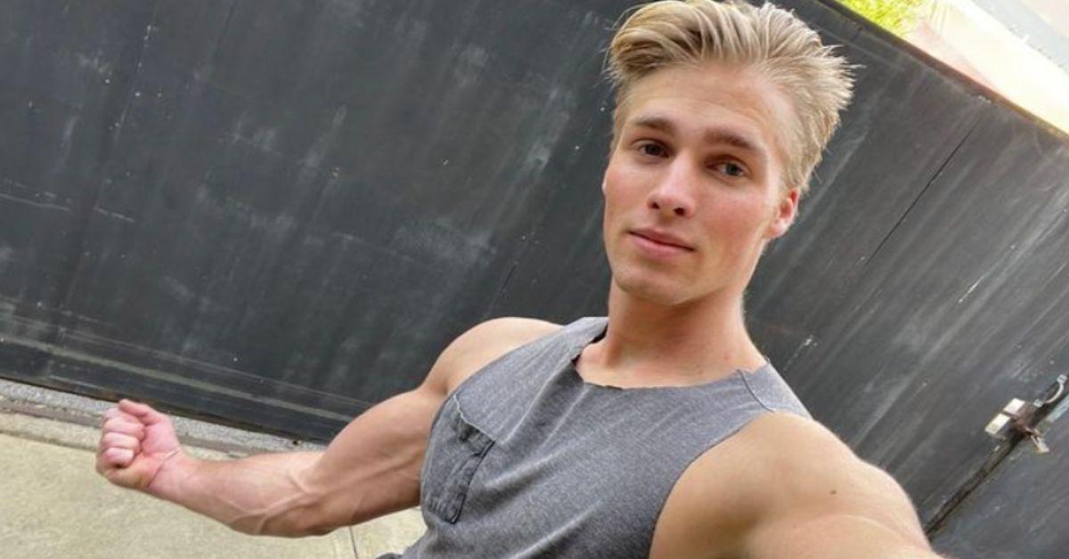 Micah Plath flexes in a gray tank top