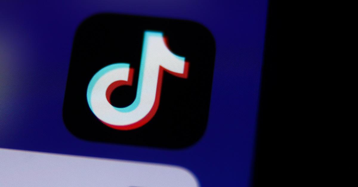 TikTok logo on a phone screen with a blue background. 