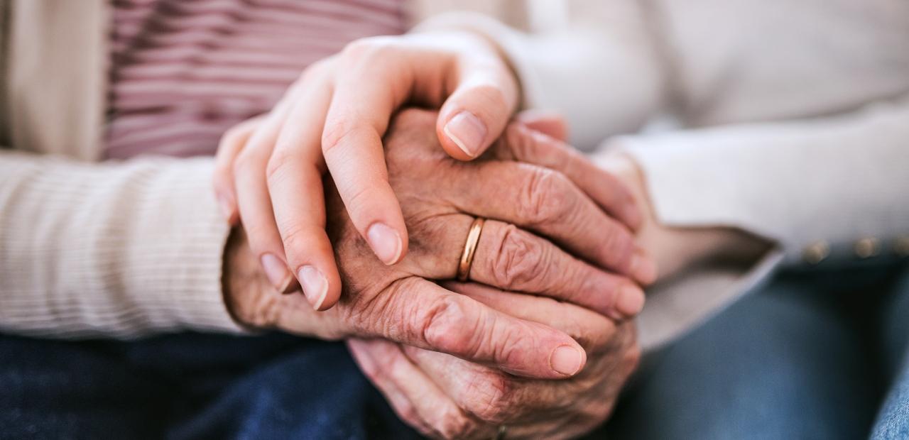 Hands of teenage girl and her grandmother at home