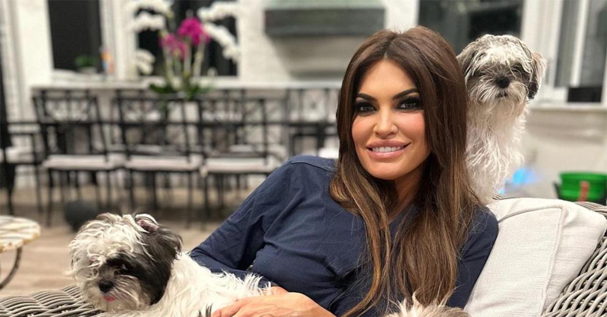 Kimberly Guilfoyle on a chair with two dogs. 