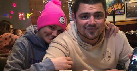 (LR) Ella Bresee in a pink hat and grey sweatshirt and Bryan Bresee in a white sweatshirt pose for a picture together