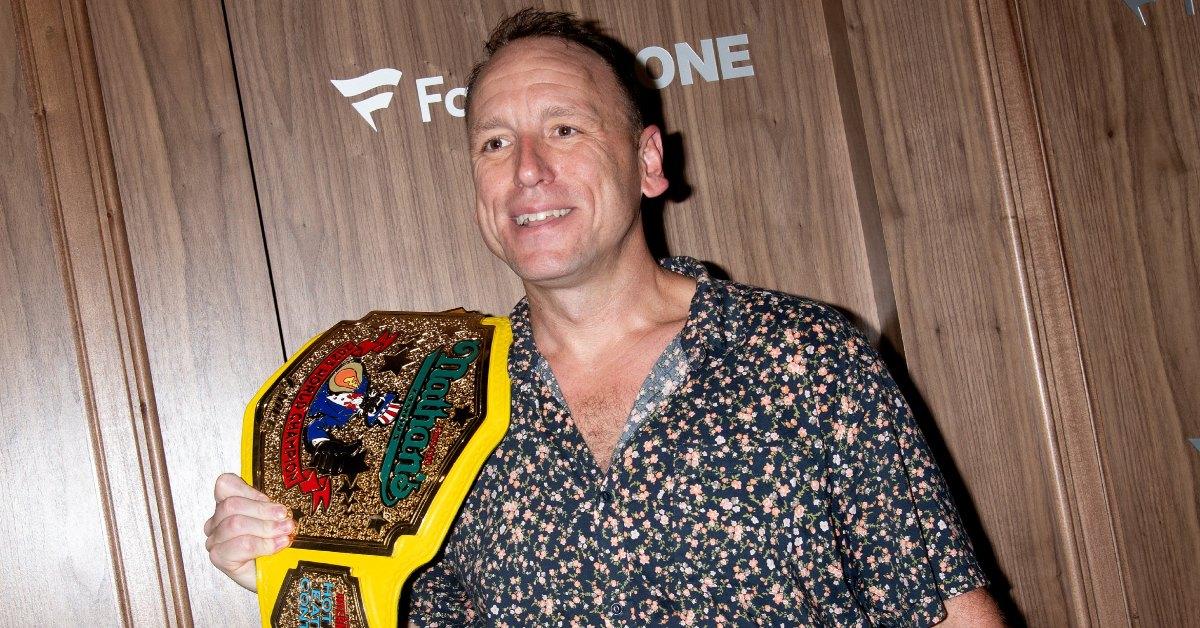 Joey Chestnut holding his belt.