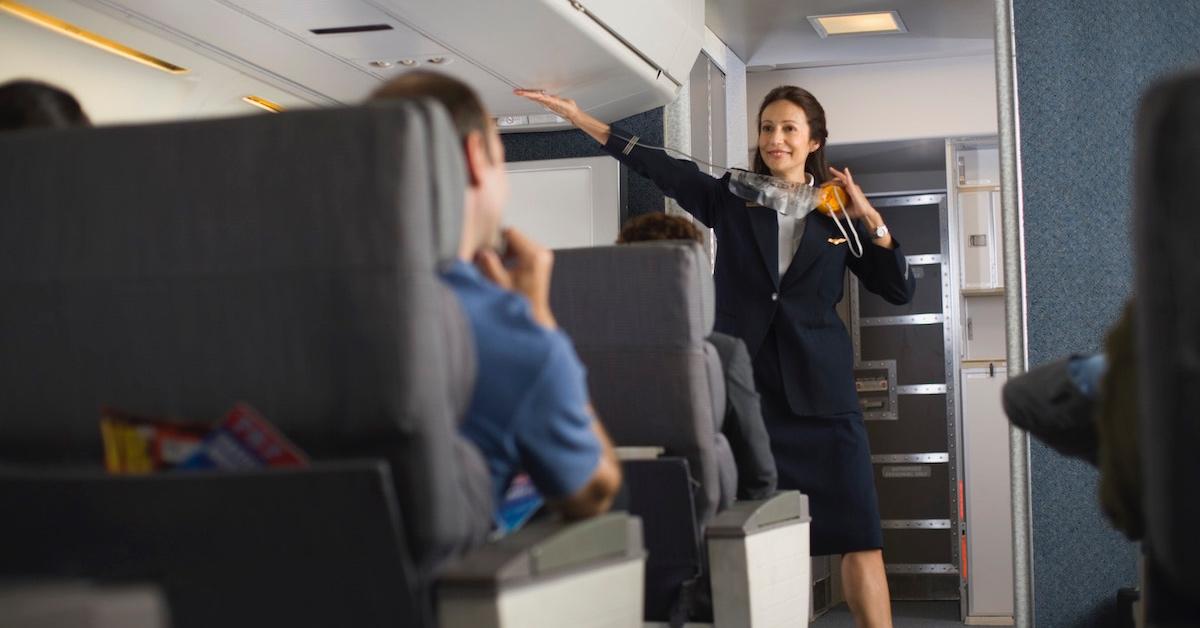 A flight attendant going through safety procedures