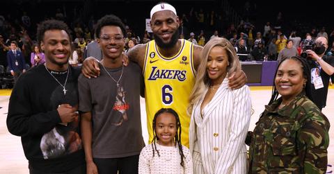 LeBron James poses for a picture with his wife, kids, and mom at the end of a game.