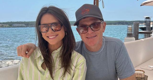 Sophie Flay sitting by the water with her father, Bobby Flay.