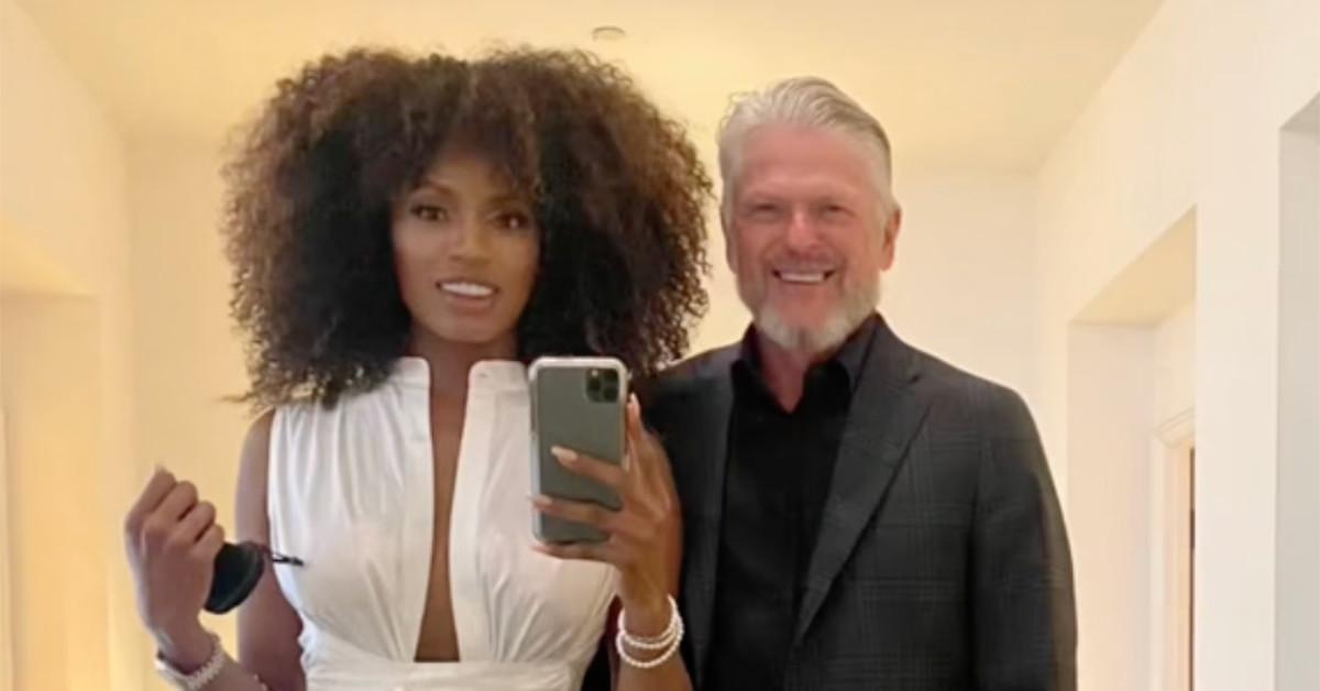 An interracial couple smiling for a photo, as seen in a "Black Wife Effect" TikTok video