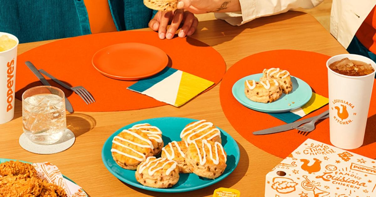 Popeyes biscuits on a table with chicken