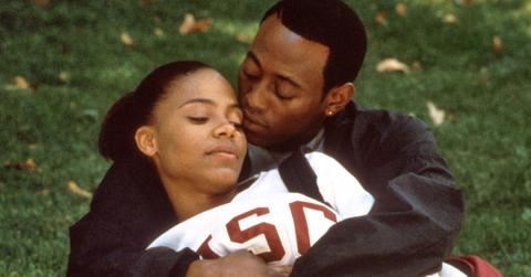 Omar Epps as Q and Sanaa Lathan as Monica cuddle on the lawn in 'Love and Basketball'.
