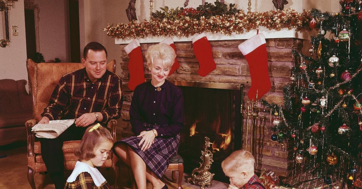 A family sitting by the fireplace at Christmas