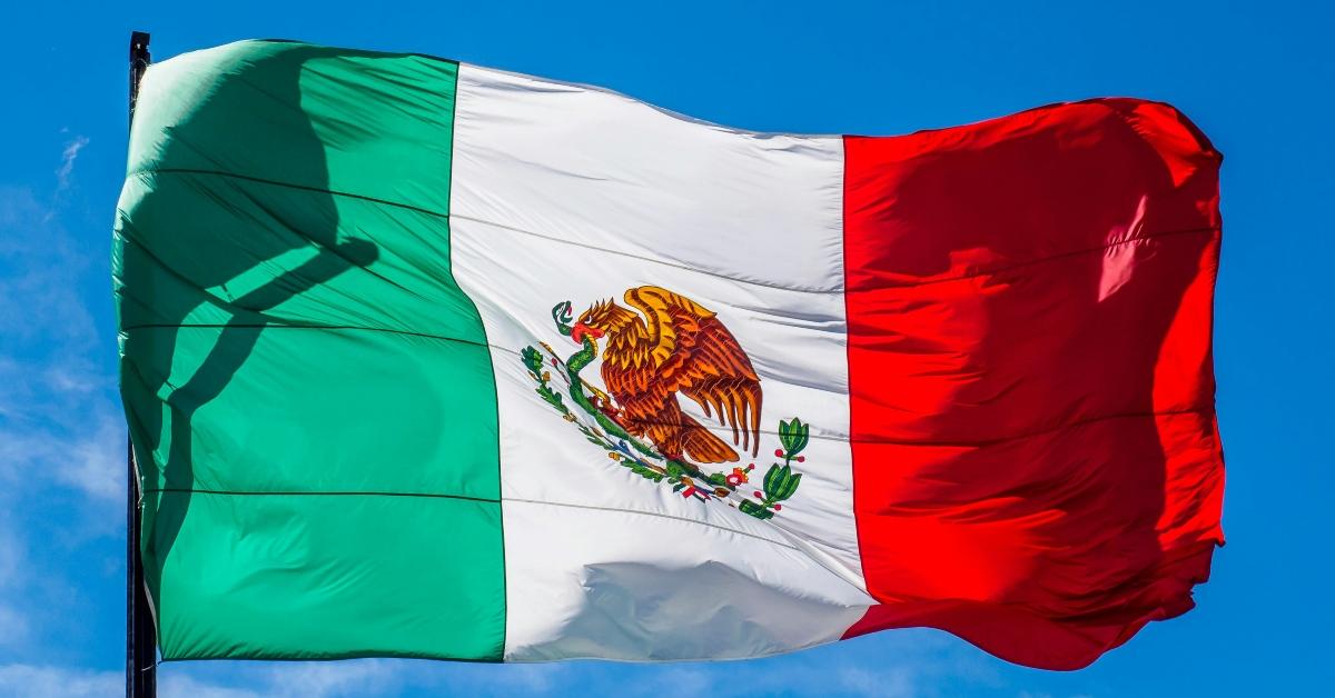 Mexican flag against a blue sky