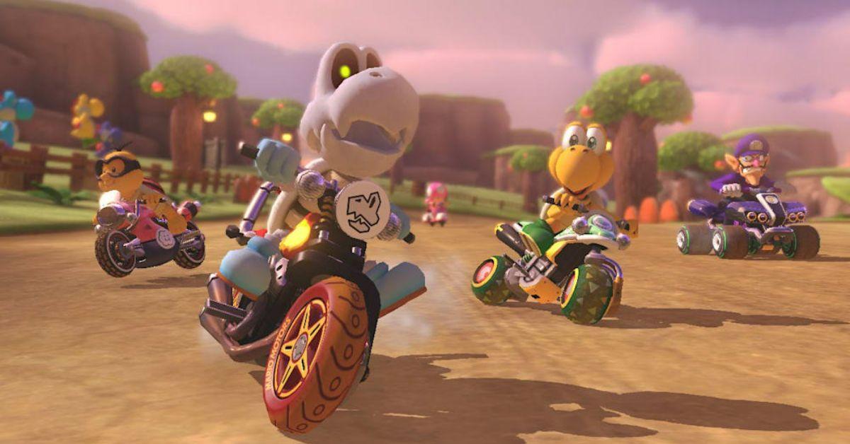 Players racing around a track in Mario Kart 8 Deluxe.