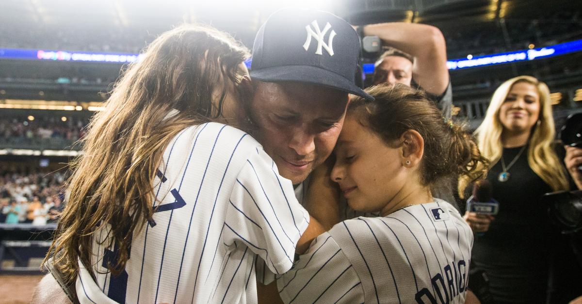 Alex Rodriguez hugs his daughters Natasha and Ella after his last game New York Yankee player on Friday, Aug. 12, 2016.