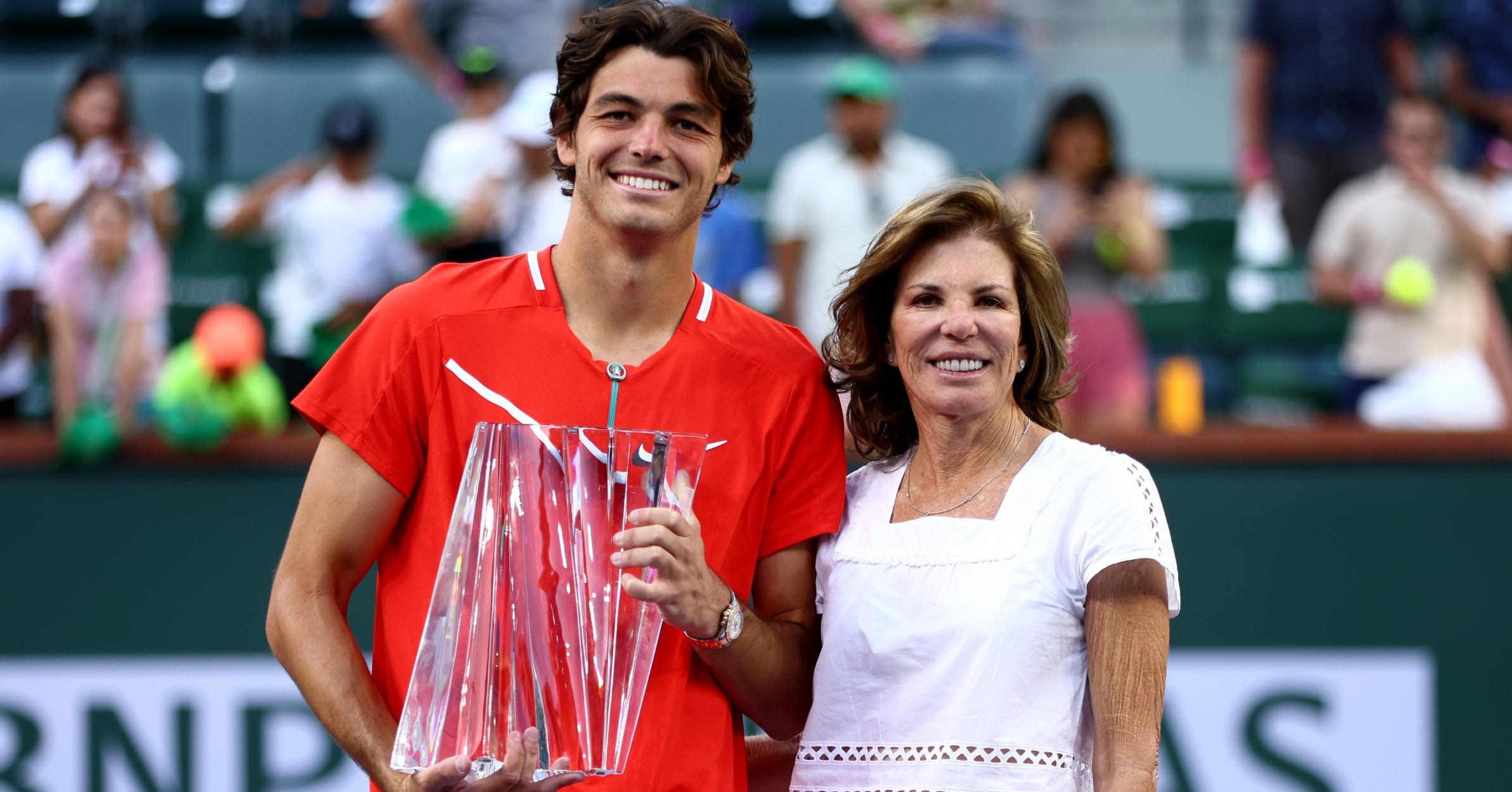 Taylor Fritz holds his winners trophy with his mother, former player Kathy May.