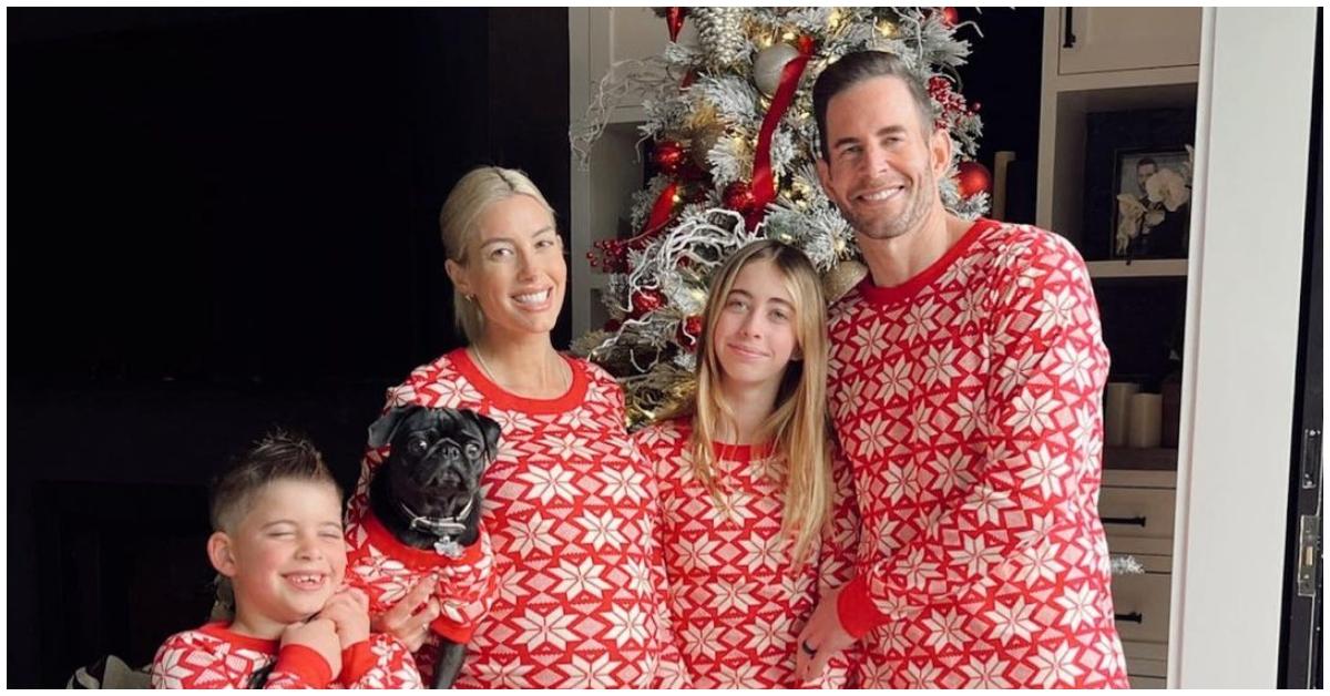 (l-r): Brayden, Heather, Taylor, and Tarek El Moussa wearing matching pajamas with their dog on Christmas Day.