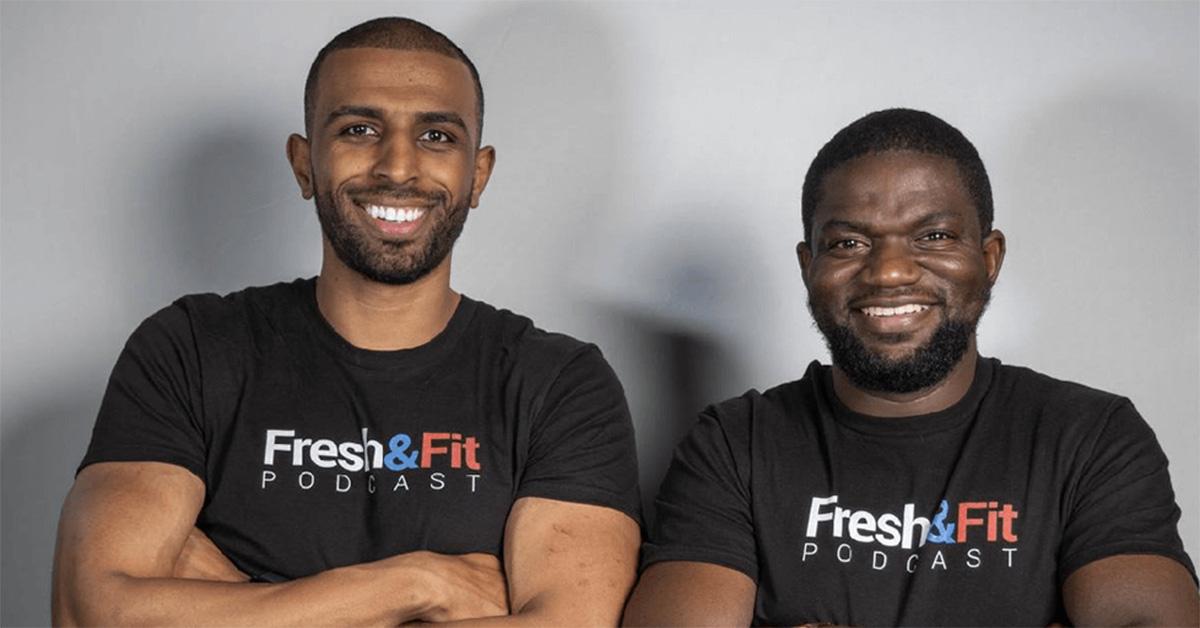 Fresh and Fit posing together with their arms crossed. 