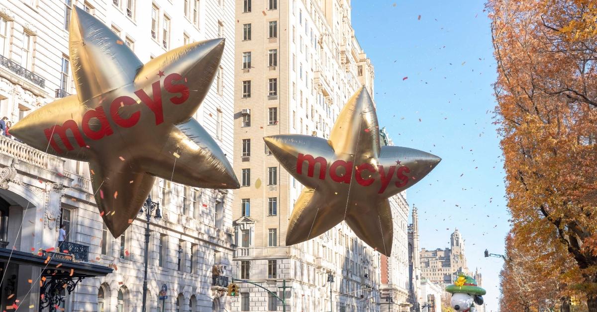 Large gold balloons with "Macy's" written on them in red take part in the annual Macy's Thanksgiving Day Parade.