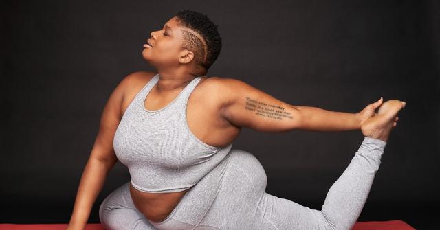 Photo of yoga instructor Jessamyn Stanley posing on a mat by Bobby Quillard