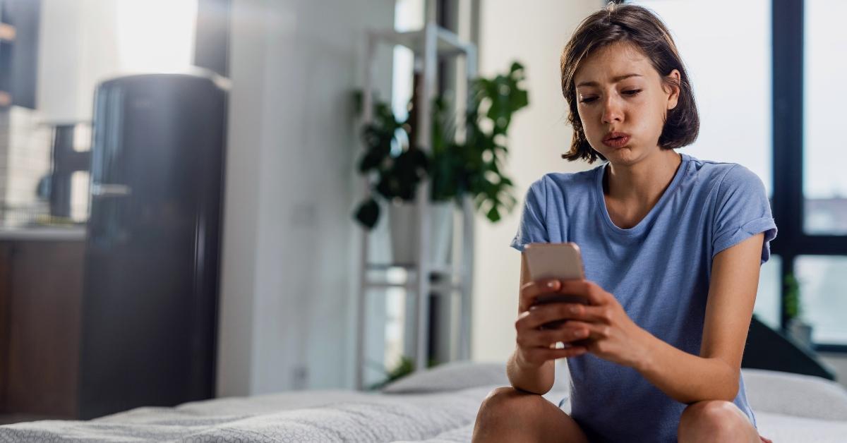 A woman looks at her phone.