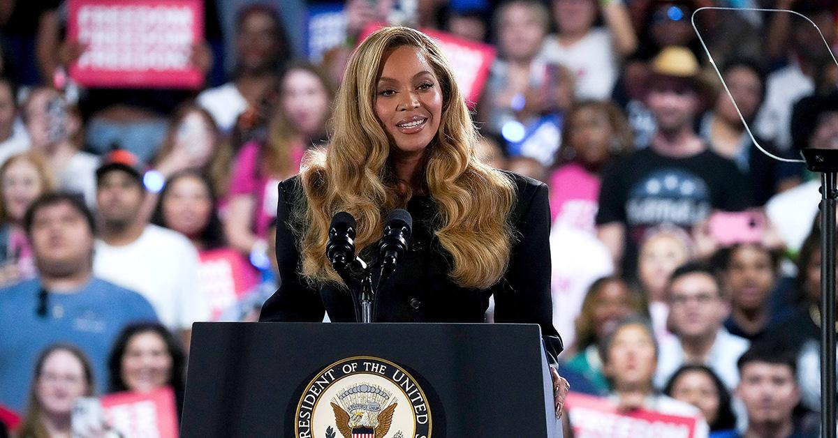 Beyonce speaking at a podium at a Kamala Harris rally. 