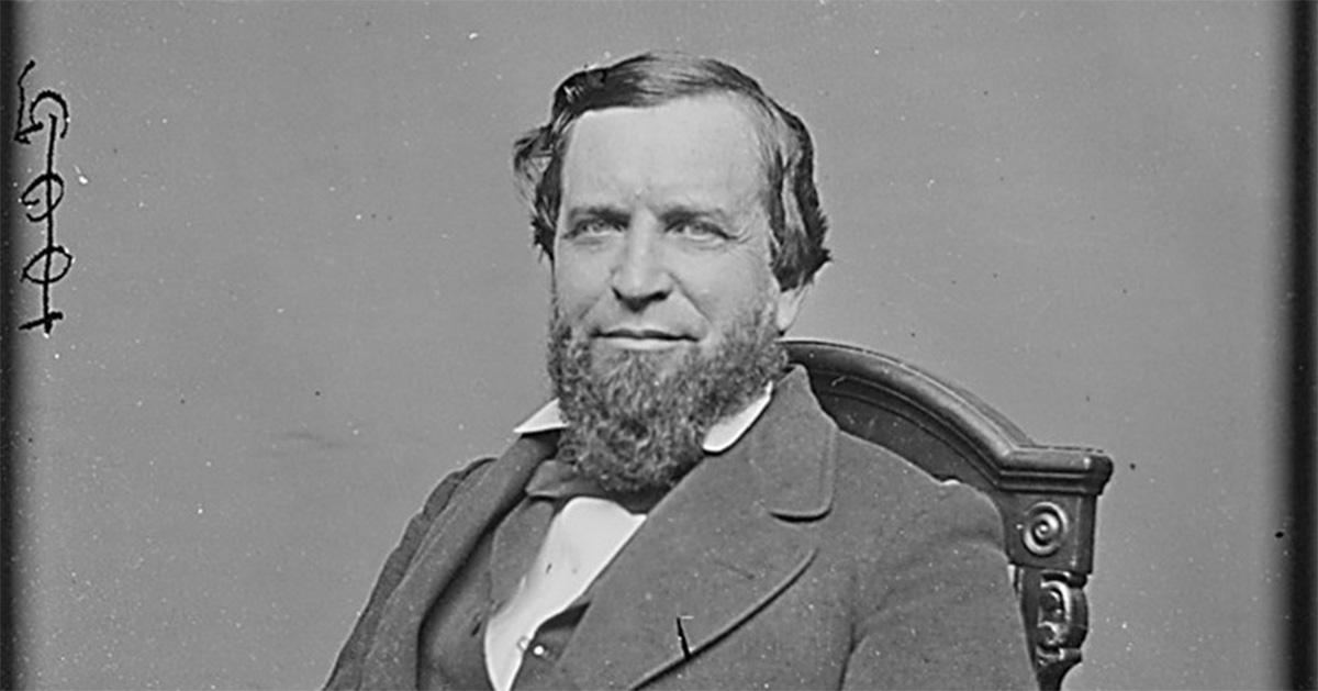 Joshua Speed sitting in a chair with a beard. 