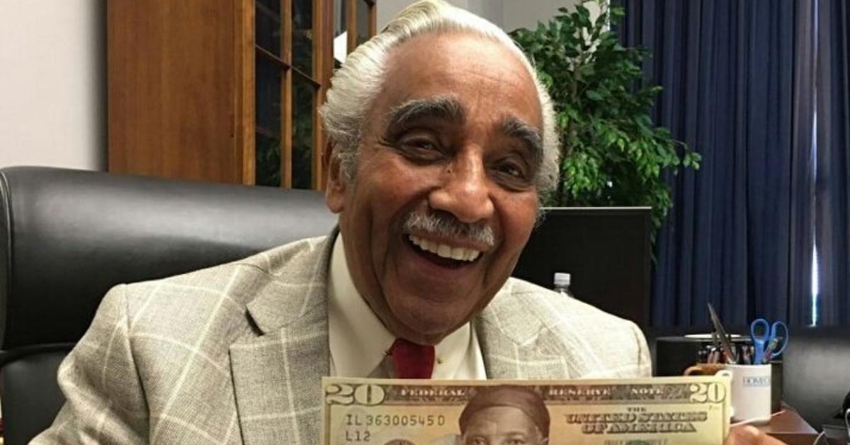 Charles Rangel holds up a Harriet Tubman bill