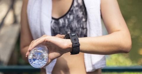 An athlete checks her smartwatch for a PR