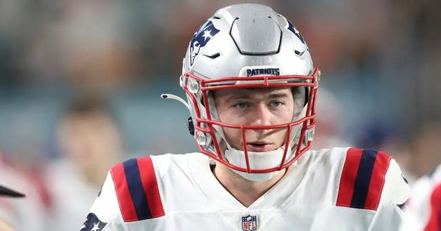 Mac Jones standing on the sideline against the Miami Dolphins on Jan. 9, 2022