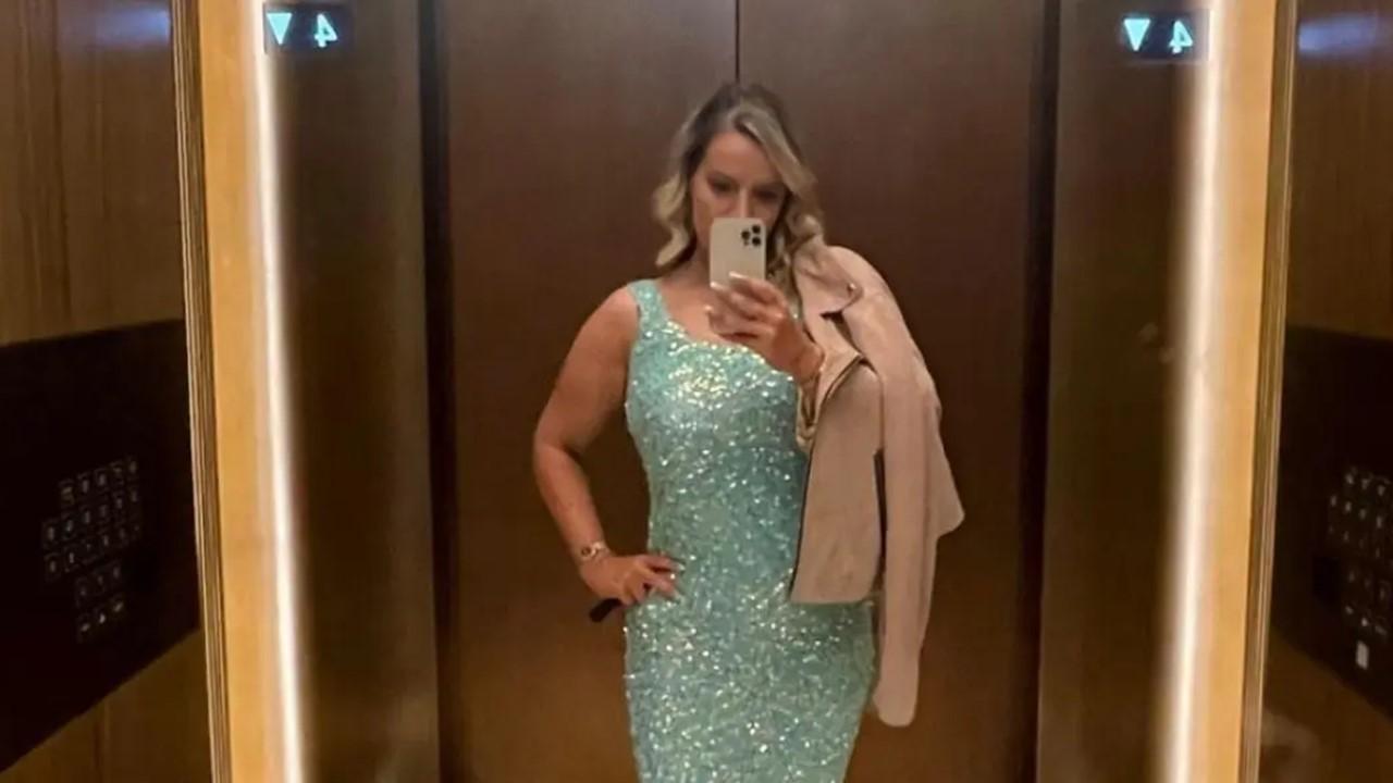 Maria Morris from 'Selling Dubai' poses in an elevator in a green sequin dress.