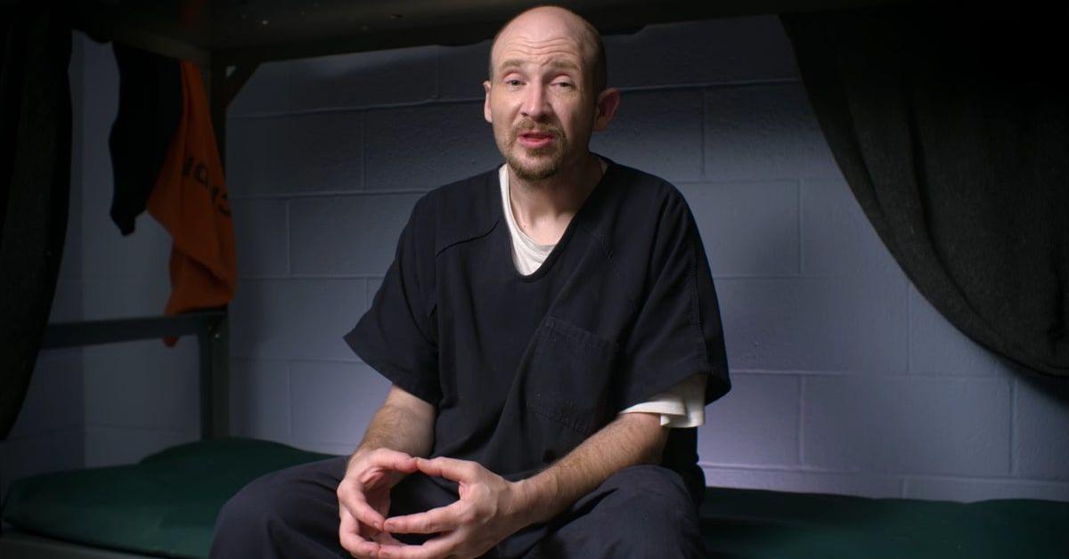 David Miller sitting on a bed in his cell and talking
