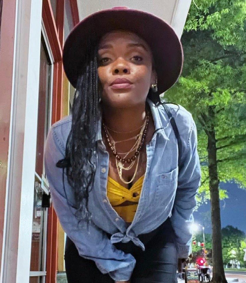 Reba Thomas posing in a blue button up.