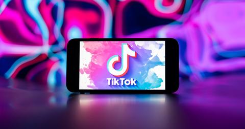 A TikTok logo with colors around it.