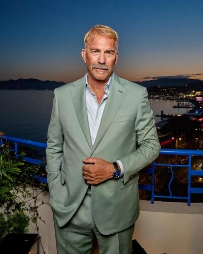 Kevin Costner in a green suit