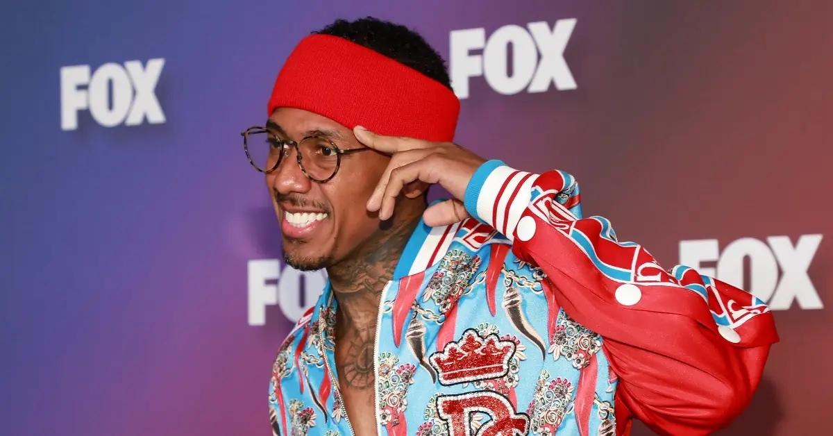 Nick Cannon wearing a blue, red, and white jacket at a Fox event.