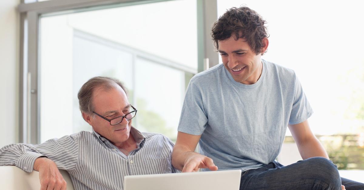 A man and his nephew looking at a laptop