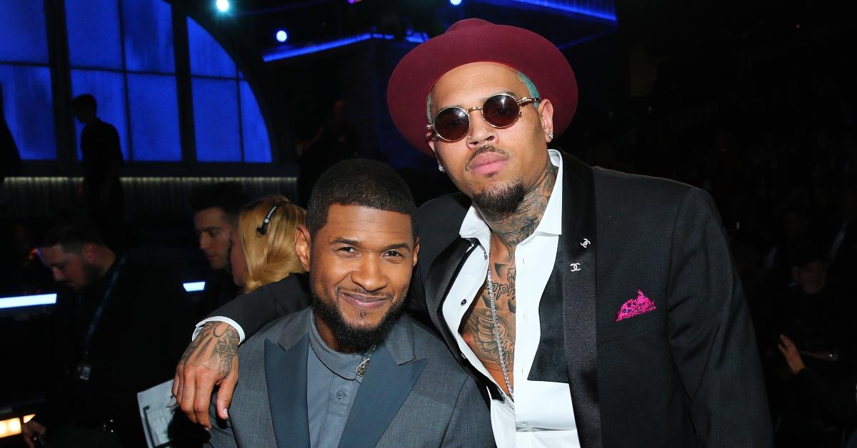 Usher and Chris Brown smile and pose at the 57th Annual GRAMMY Awards. 