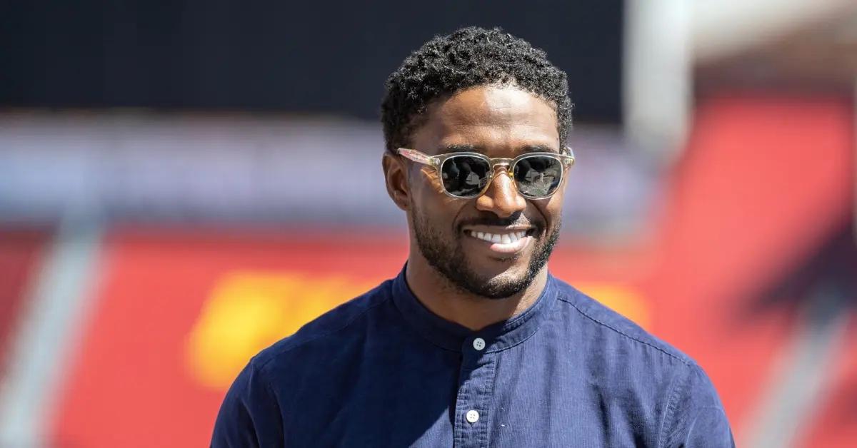 Reggie Bush wearing a blue shirt and shades in 2023.