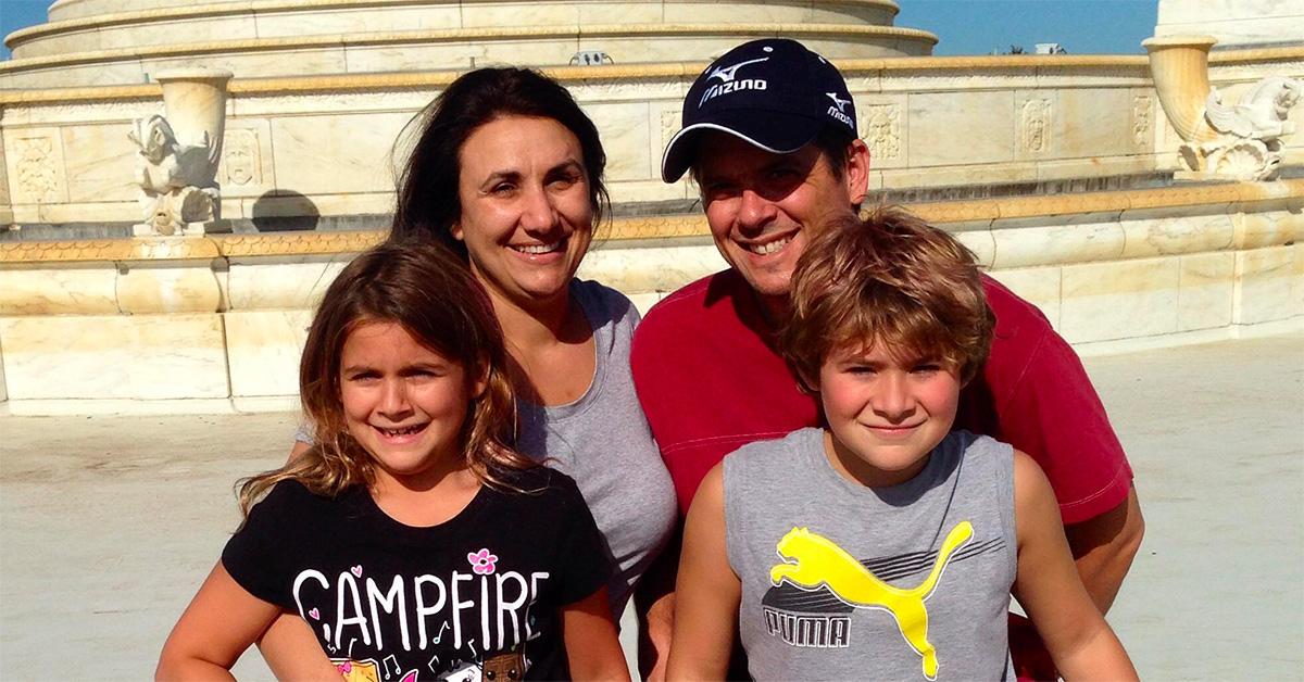 Brandon Roux with his wife and kids in front of a fountain. 