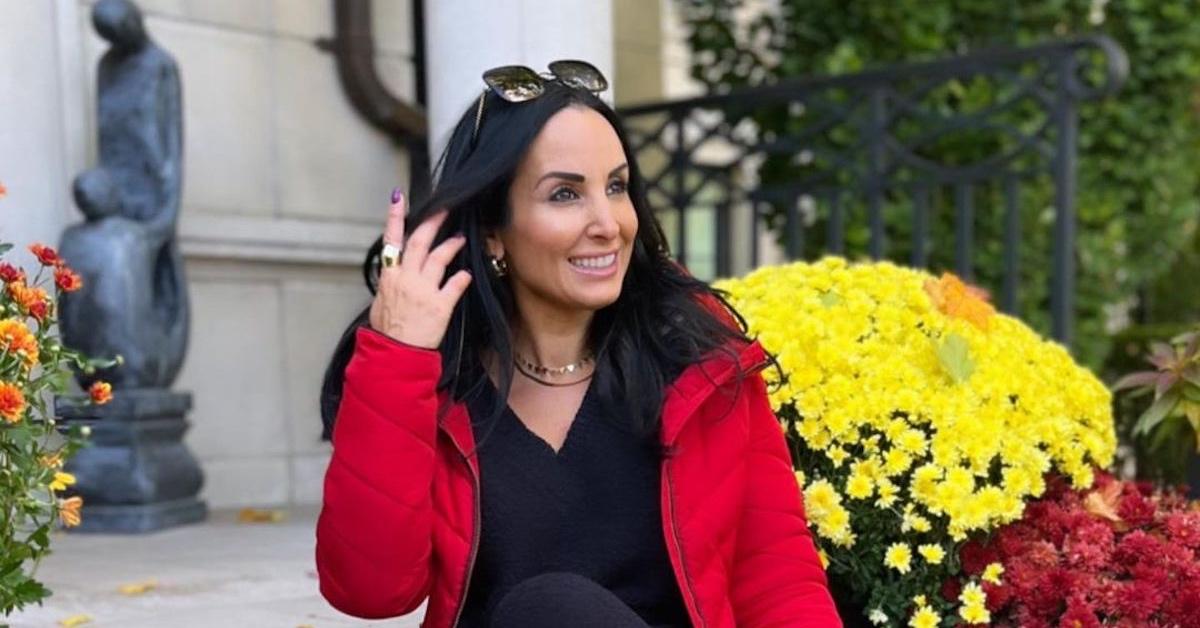 Sabrina Strasser posing in front of her home