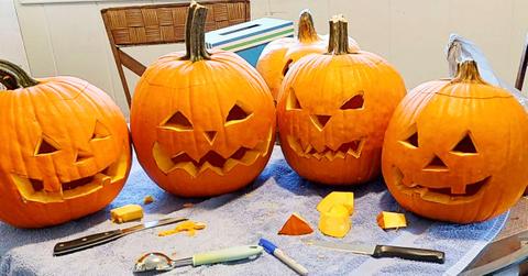 A bunch of carved pumpkins sitting on a towel