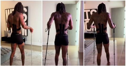 Wiz Khalifa in underwear uses walking sticks to get around.