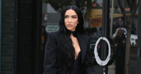 Bre Tiesi on the street in Los Angeles in a black suit.