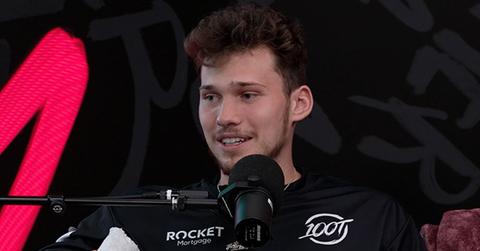 Jesser sitting in front of a mic for a podcast
