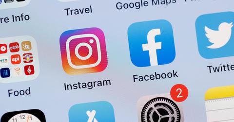 Instagram and Facebook logos on a phone screen.