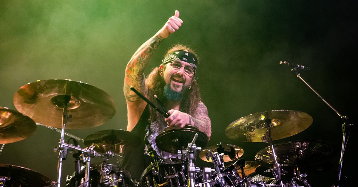 Mike Portnoy performing on stage with Sons of Apollo. 