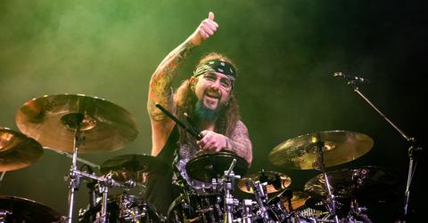 Mike Portnoy performing on stage with Sons of Apollo.