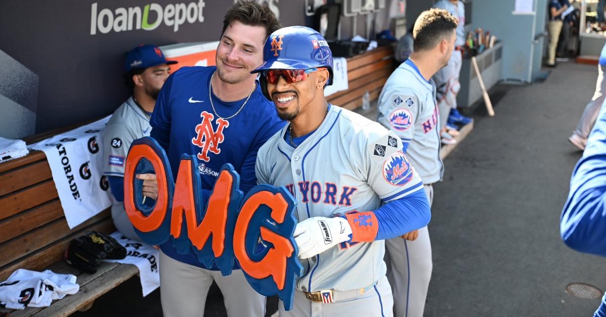 Members of the New York Mets holding up the "OMG" sign. 