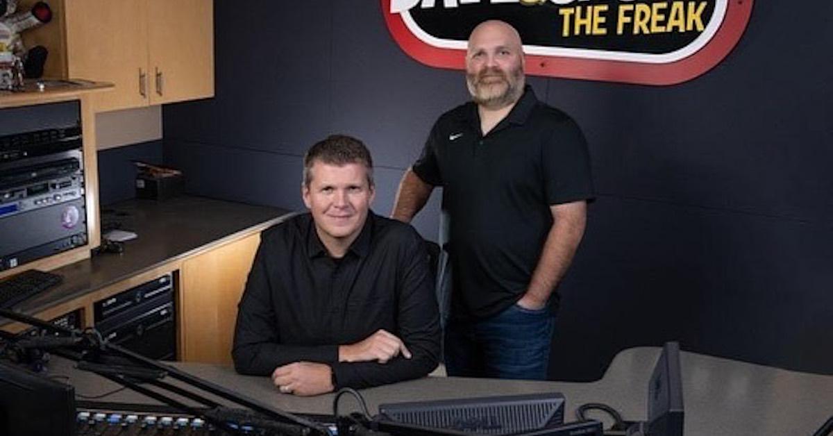 Dave and Chuck in the studio, both wearing black collared shirts and smiling