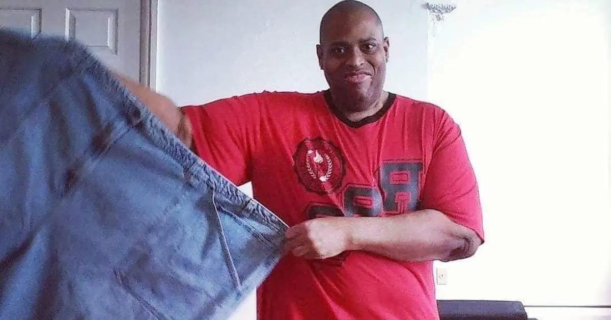 Larry Myers shows off his weight loss by comparing his current weight to a large pair of pants.