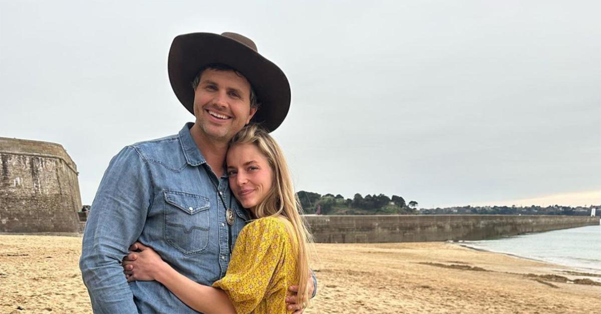 Hannah and Daniel Neeleman posing together on the beach. 