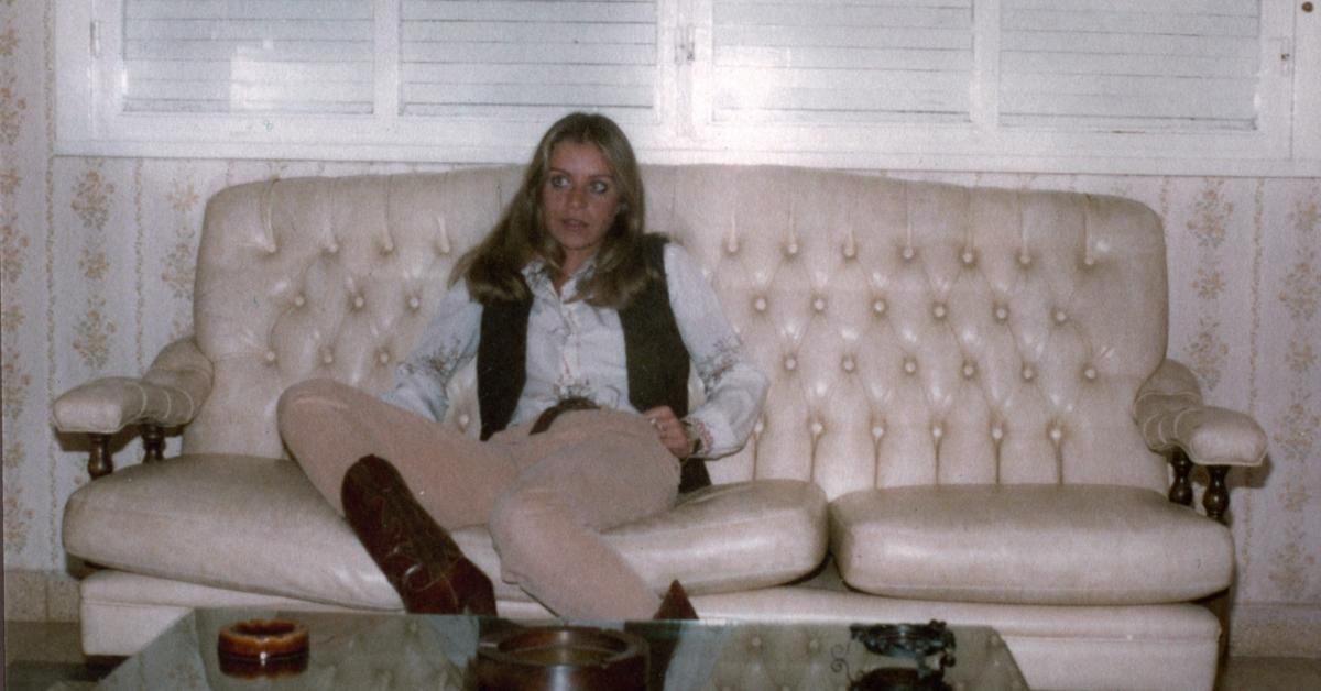 Nora Delmasso on a couch in her home